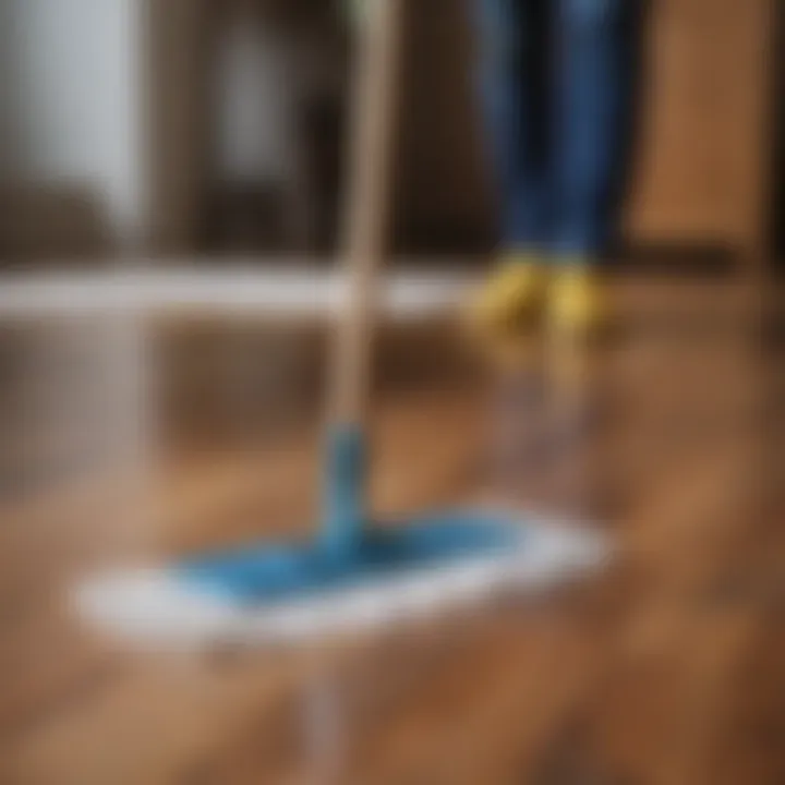 A person using a microfiber mop on a wooden floor, demonstrating an effective cleaning technique